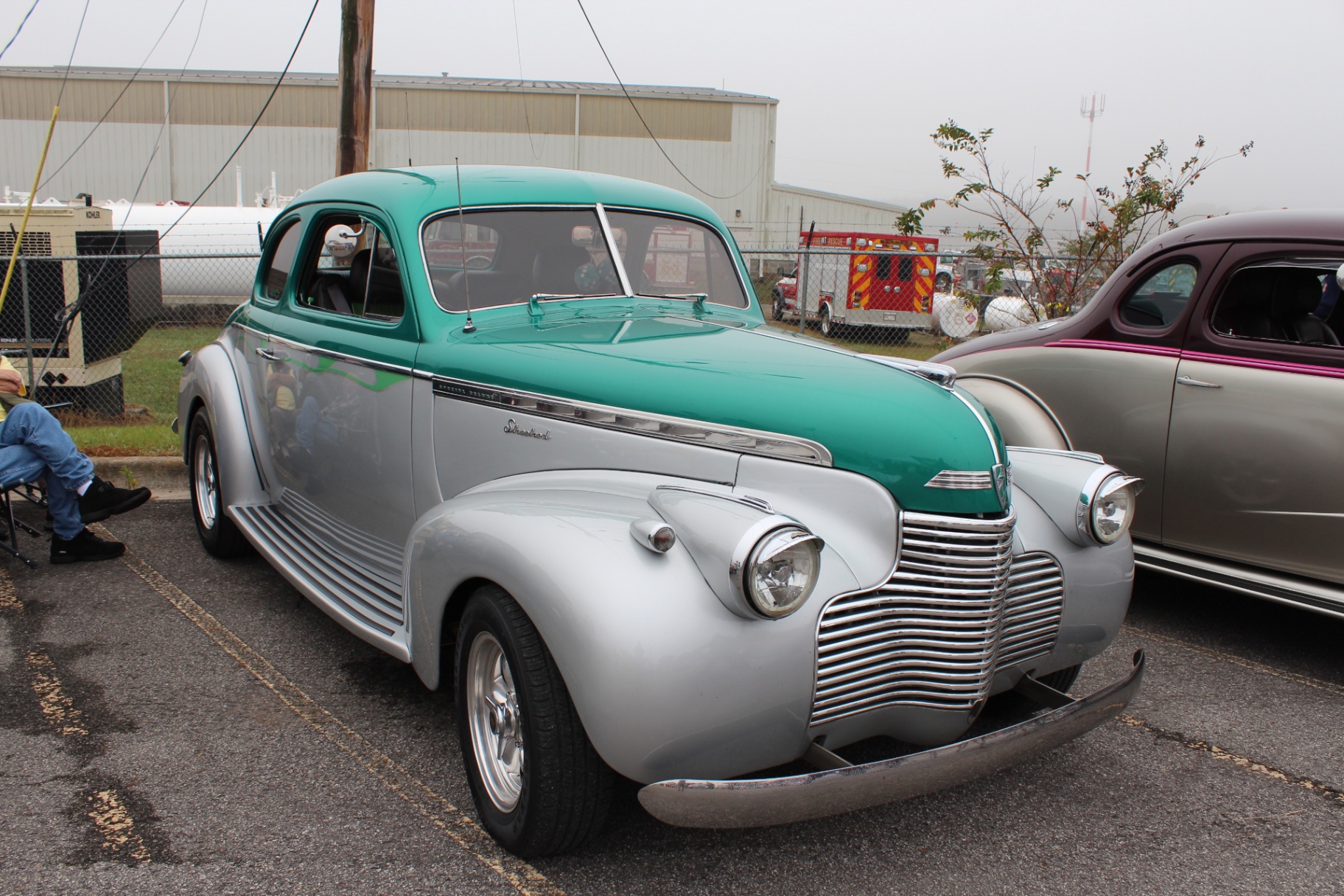 Teal-and-silver 1940s Chevrolet street rod in the car show