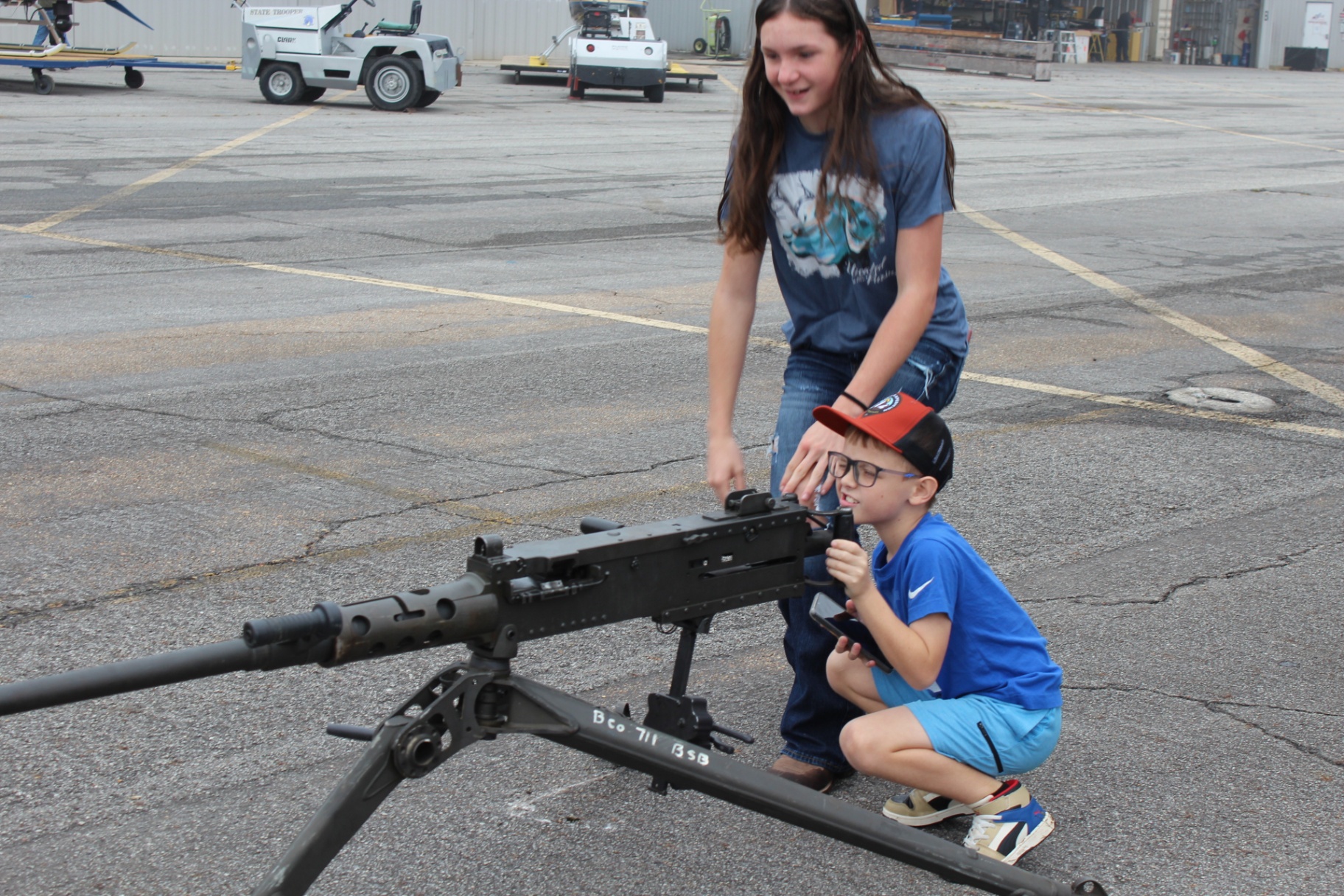 Kids get hands-on with a mounted M2 .50 cal display