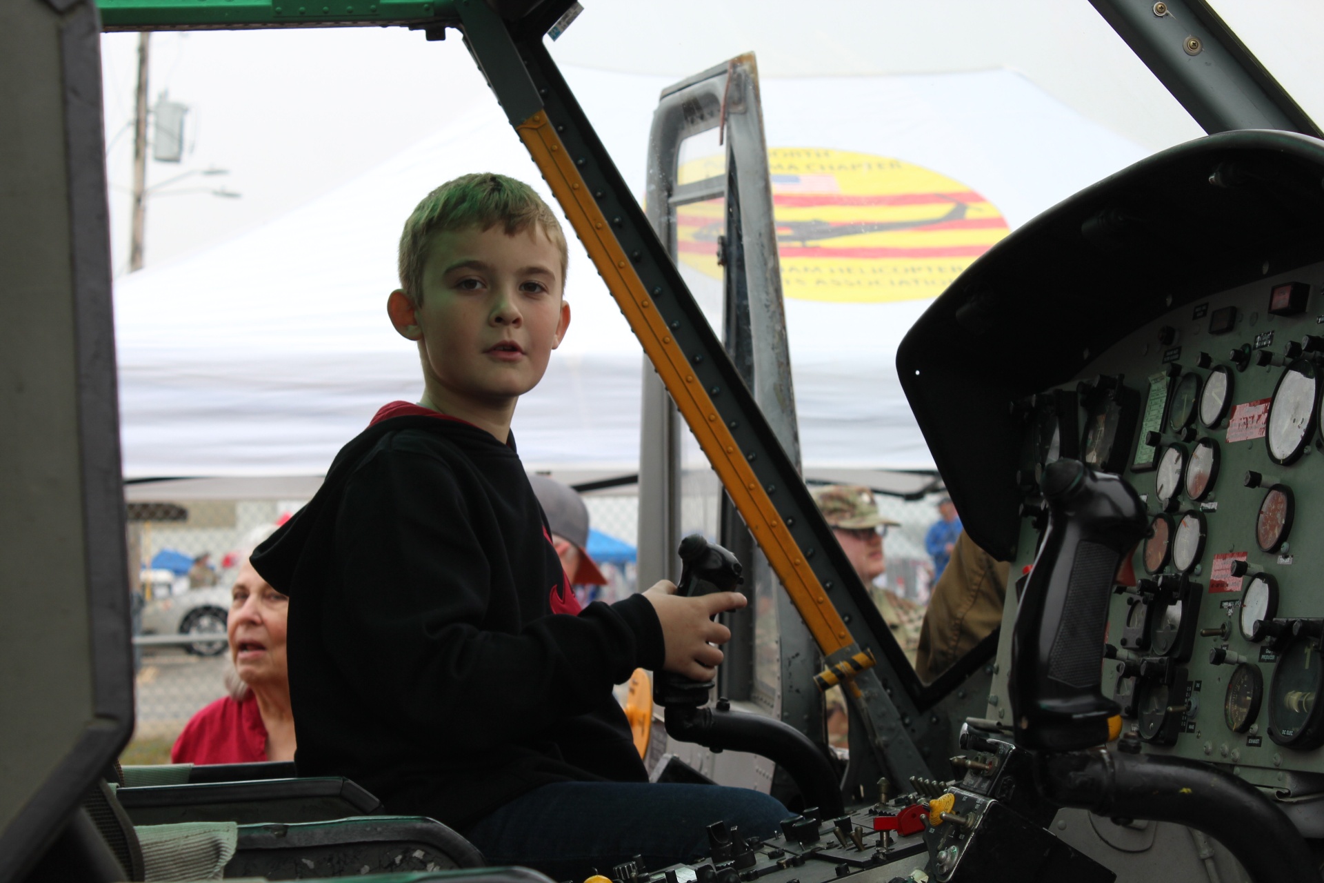 Young visitor at the controls of a Vietnam-era Huey cockpit