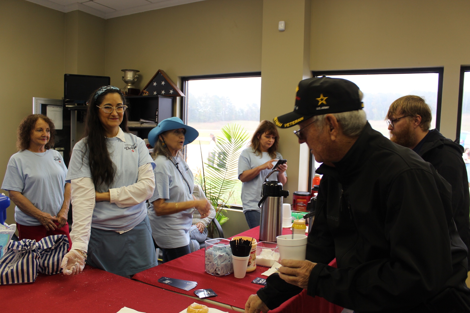 Doughnut Dollies serve coffee to a Vietnam veteran at The Landing