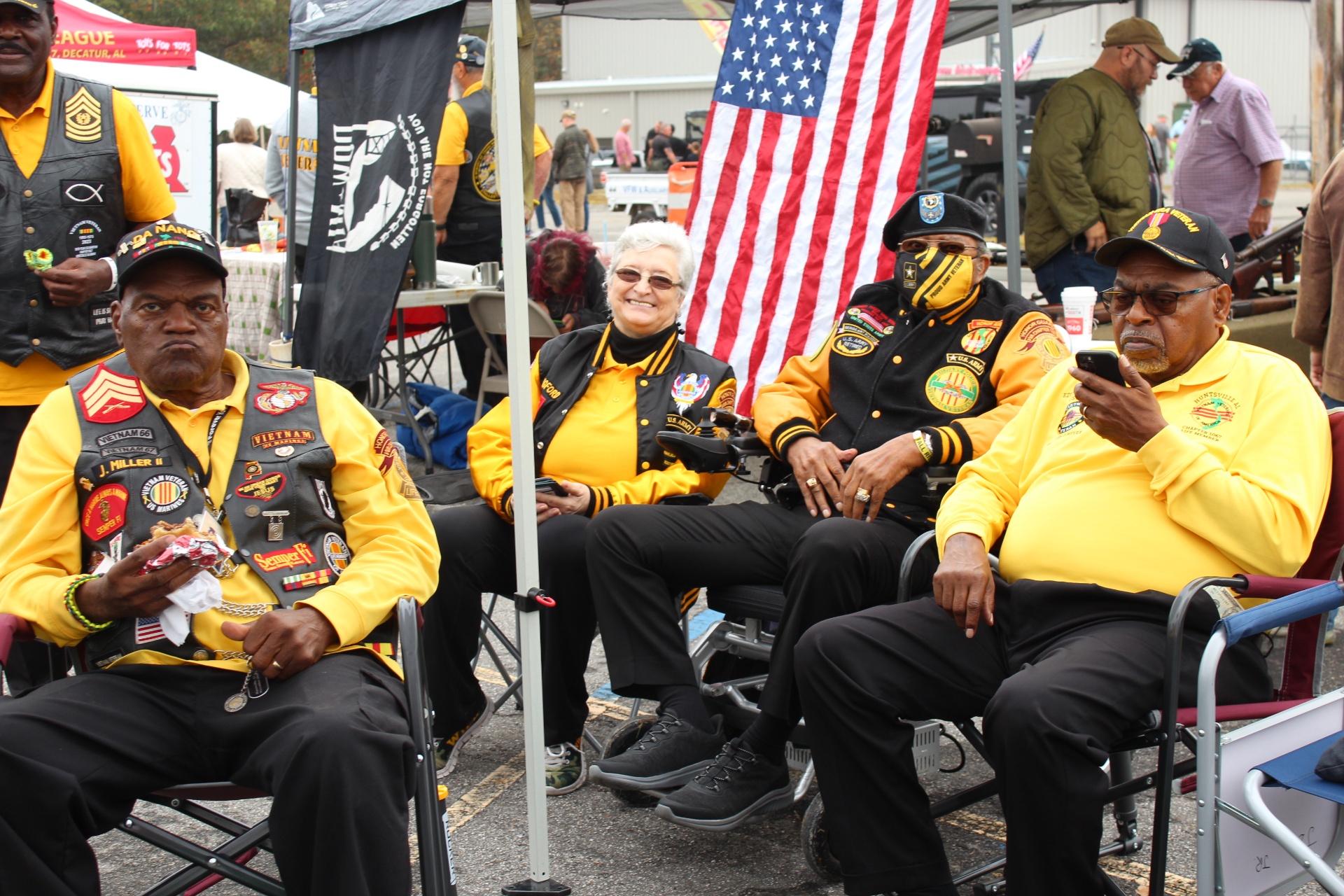 Vietnam Veterans of America members seated beneath the colors