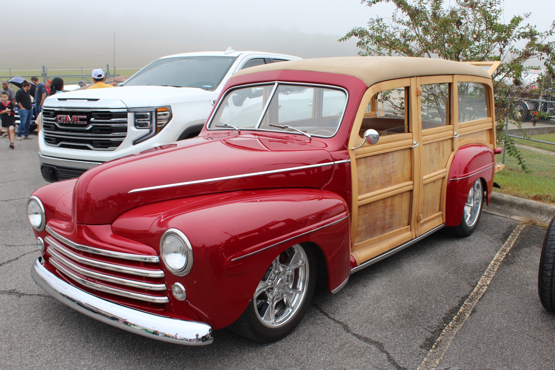 Restored red 1940s Ford woody wagon parked on the ramp