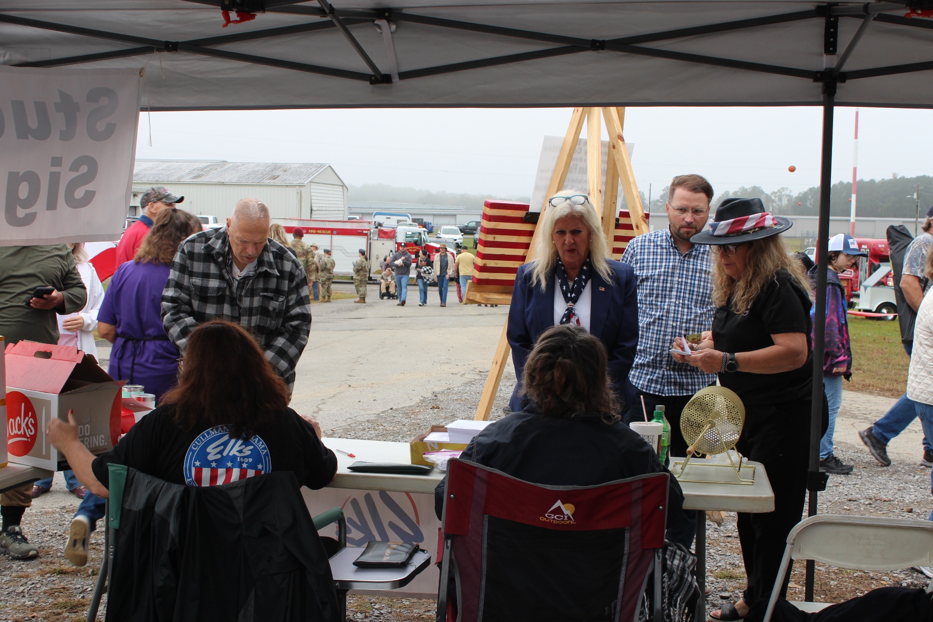 Volunteers register students at the Elks Lodge tent