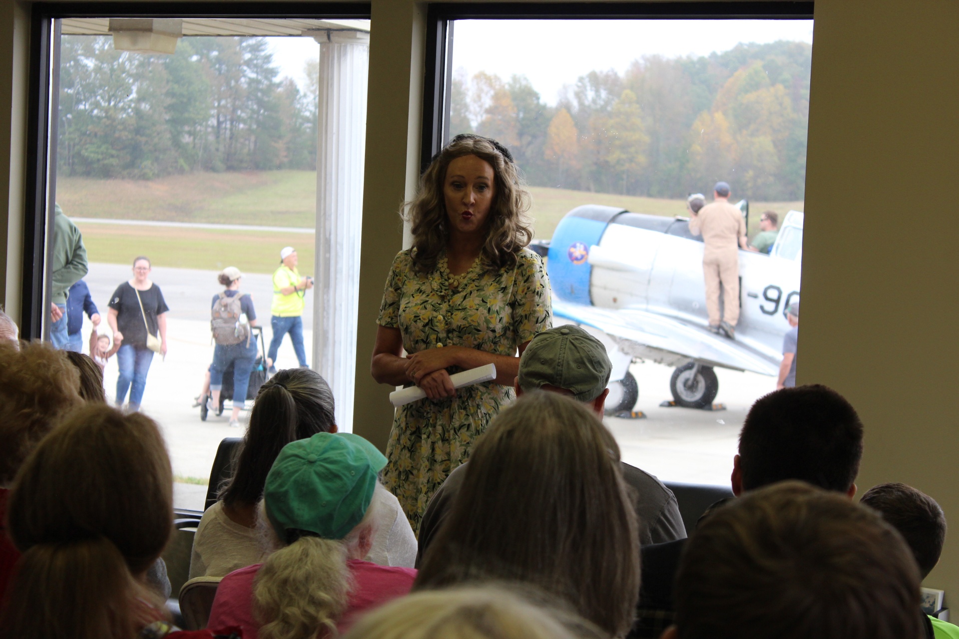 USO-era presenter speaking to a hangar audience