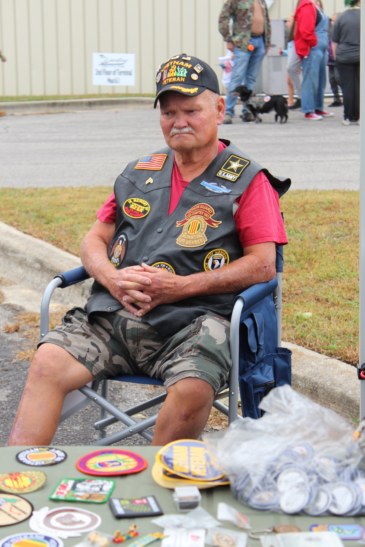 Vietnam veteran with Honor Guard patches at his display