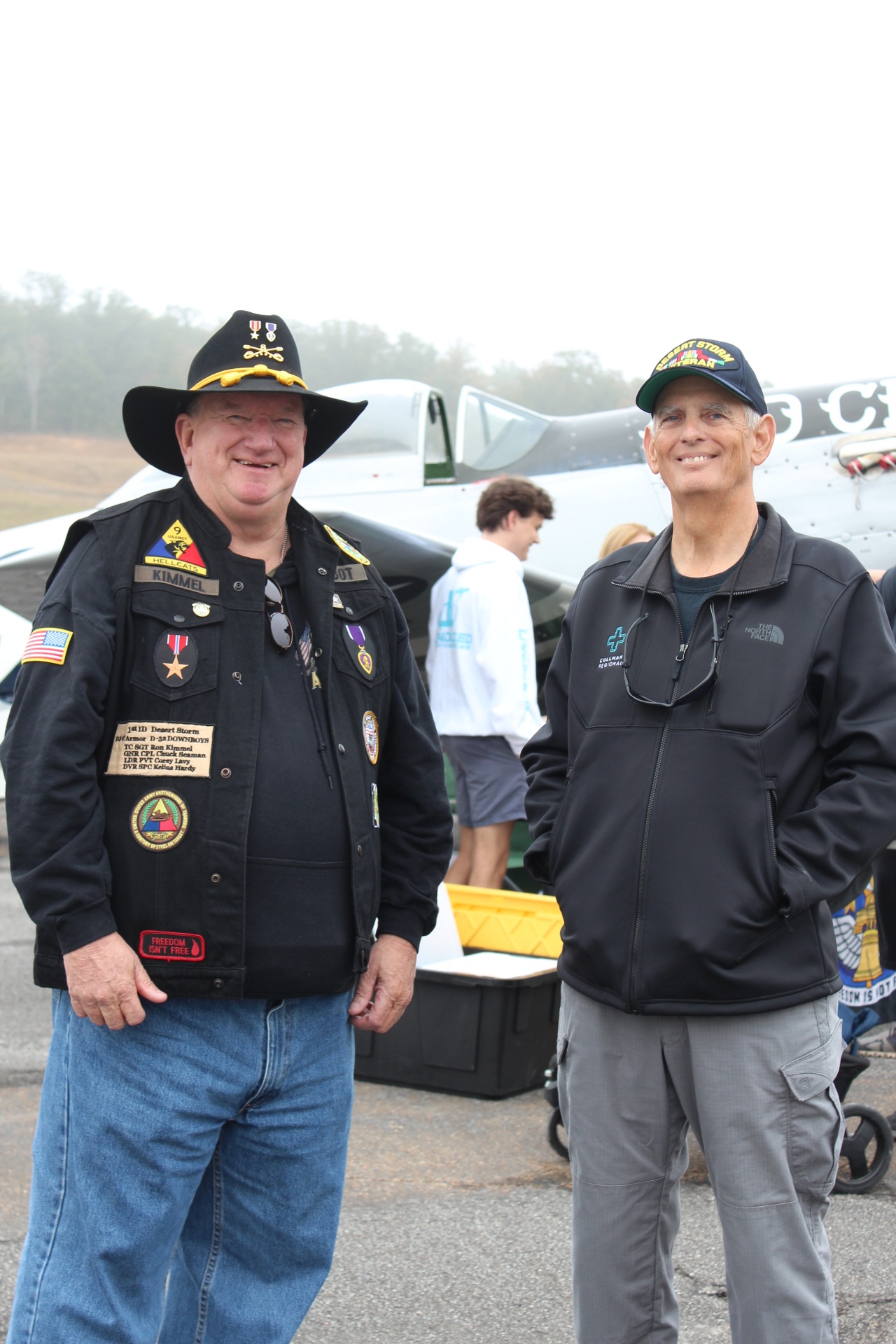 1st ID Desert Storm veteran and community member beside a P-51